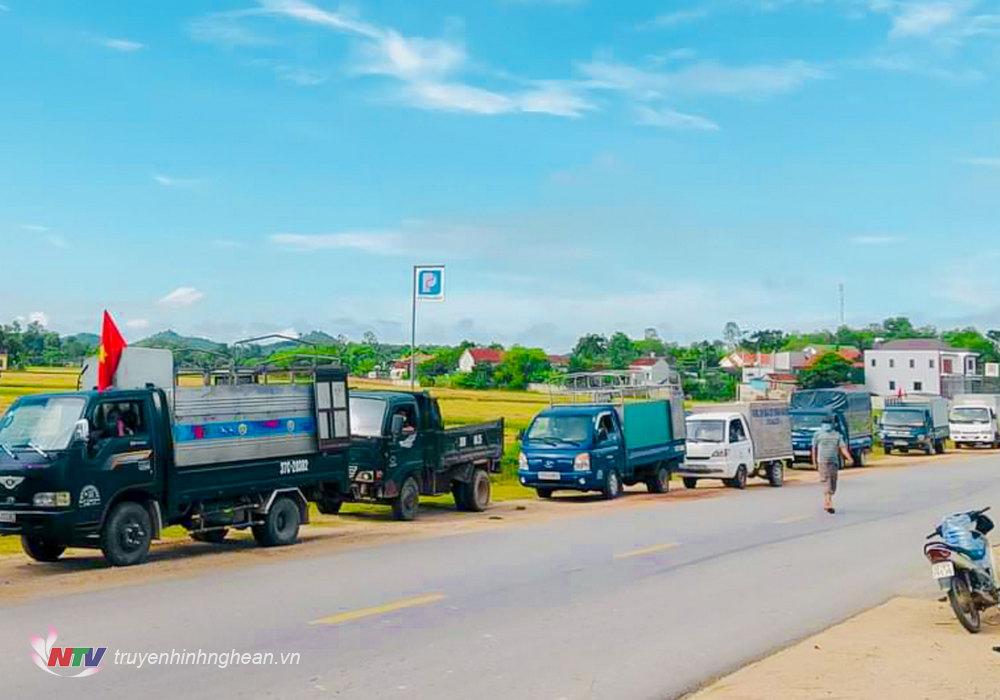 Đoàn xe tải hỗ trợ vận chuyển lúa thu hoạch về cho người dân.