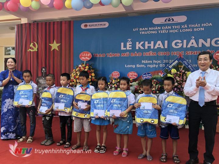 Lãnh đạo thị xã Thái Hòa tặng quà cho cáo em học sinh.
